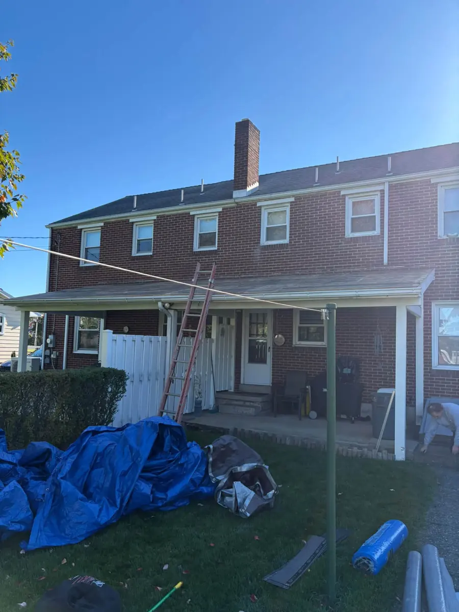 Tarps protecting the yard during a roof job