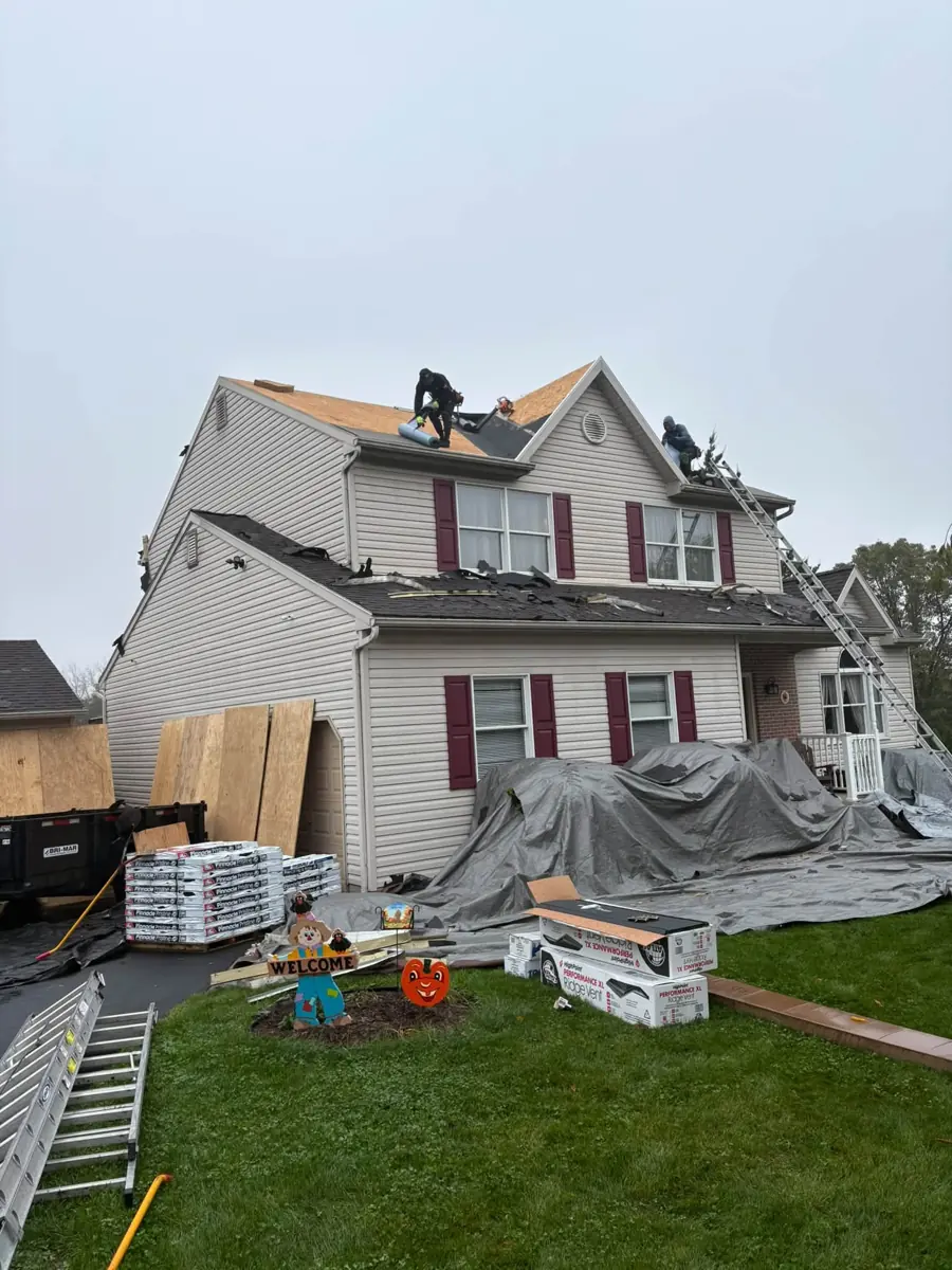 Tear-off in progress on a two-story home