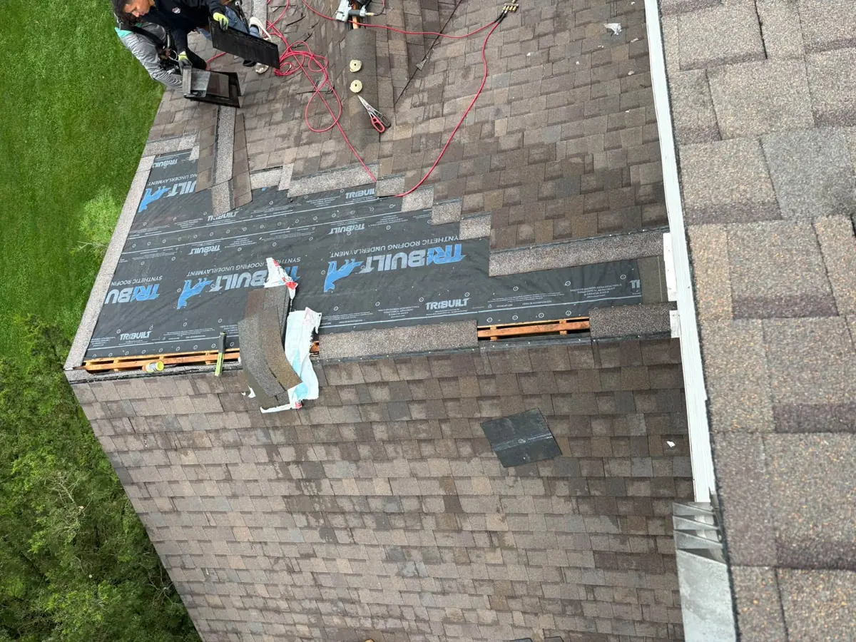 Synthetic underlayment going down on a roof